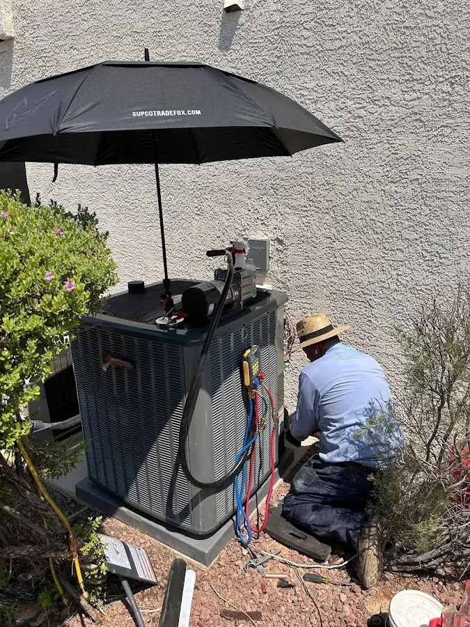 HVAC technician performing outdoor AC maintenance in Lower Allen
